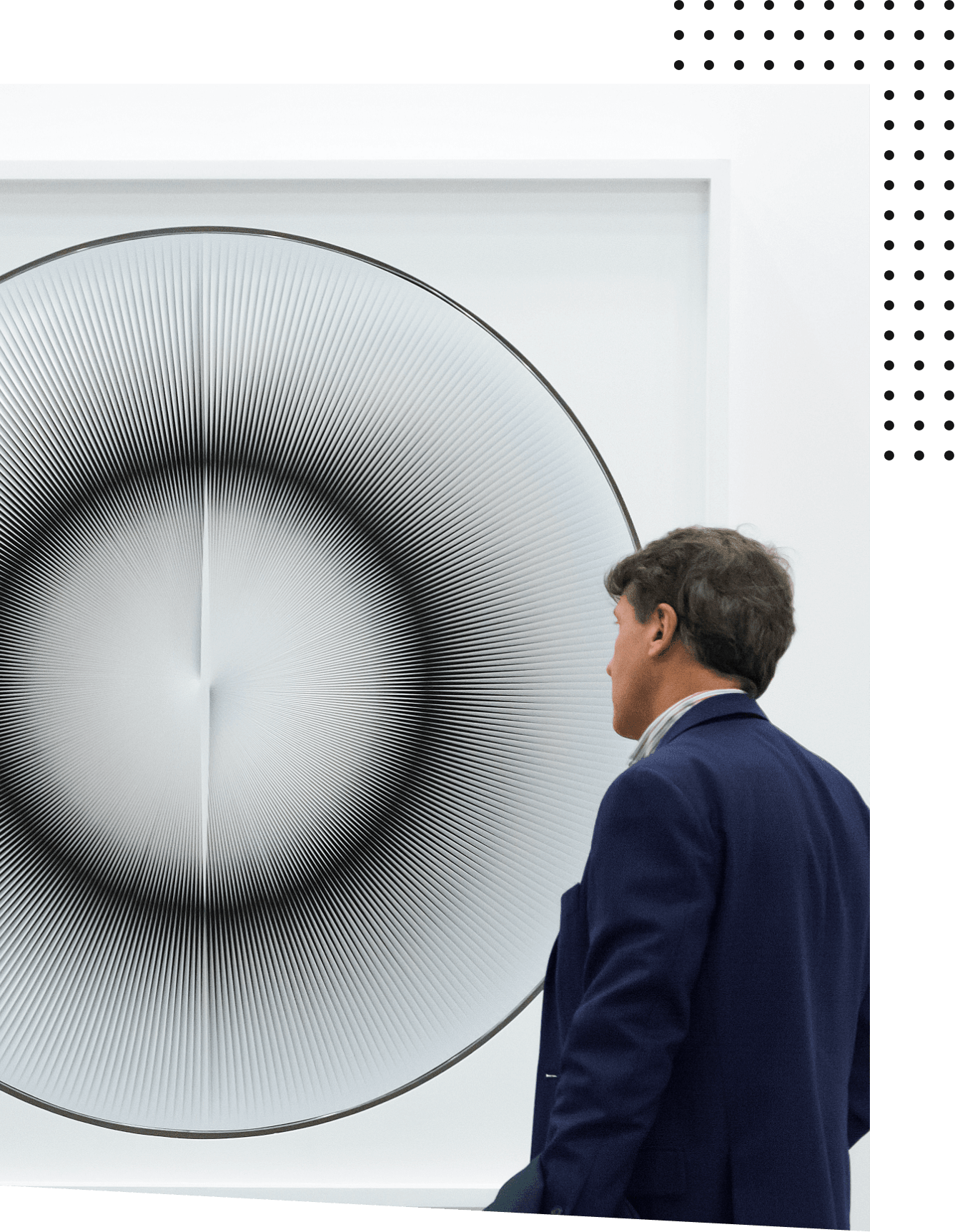 A female art lover sitting in front of abstract artwork at an international museum.